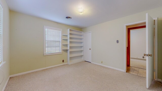 unfurnished bedroom with light colored carpet