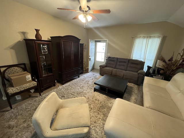 living room featuring ceiling fan, light colored carpet, and lofted ceiling