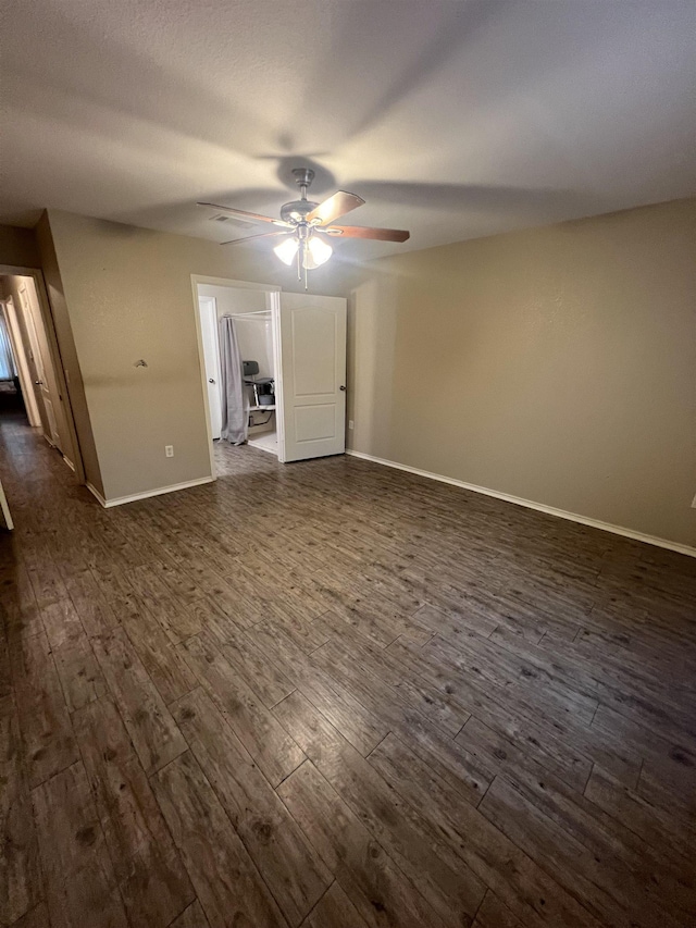 spare room featuring dark hardwood / wood-style flooring and ceiling fan