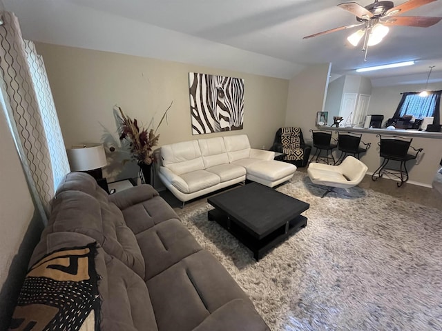 living room featuring lofted ceiling, hardwood / wood-style floors, and ceiling fan