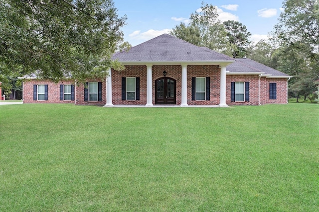 view of front of property with a front yard and french doors