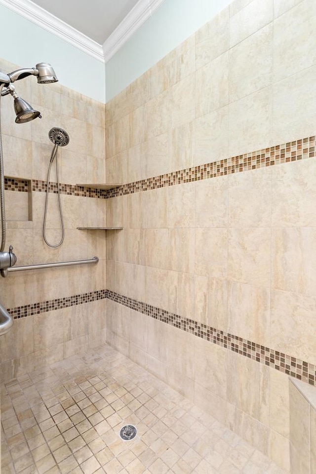 bathroom with tiled shower and ornamental molding