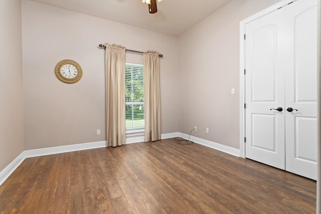 spare room with ceiling fan and dark hardwood / wood-style flooring