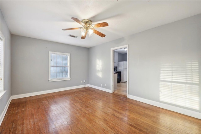 unfurnished room with hardwood / wood-style floors and ceiling fan