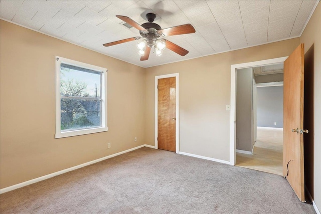 unfurnished bedroom featuring light carpet and ceiling fan