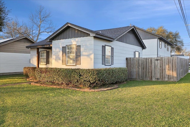 view of side of property with a yard