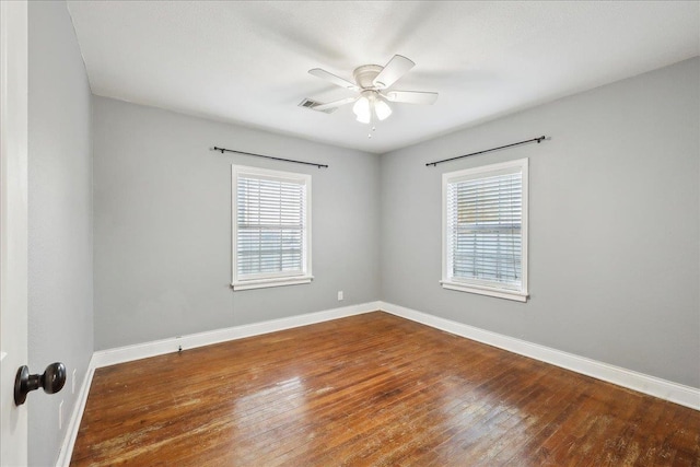 unfurnished room featuring a healthy amount of sunlight, hardwood / wood-style flooring, and ceiling fan