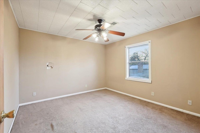 carpeted spare room with ceiling fan