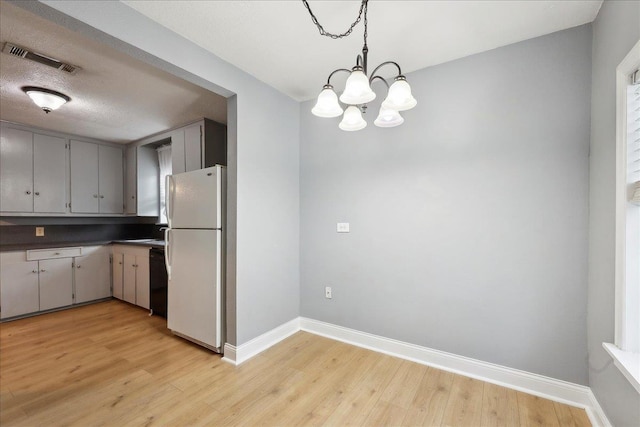 kitchen with gray cabinetry, decorative light fixtures, light hardwood / wood-style floors, white fridge, and dishwasher