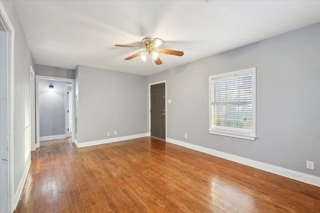 empty room with ceiling fan and wood-type flooring