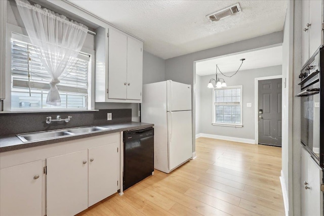 kitchen featuring light hardwood / wood-style flooring, sink, pendant lighting, black appliances, and white cabinets