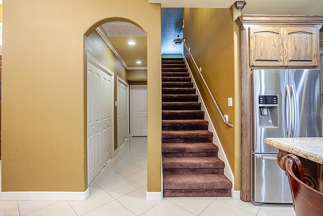 3812 Debbie Ave, Groves, TX 77619 - stairs with crown molding, arched walkways, tile patterned floors, and baseboards