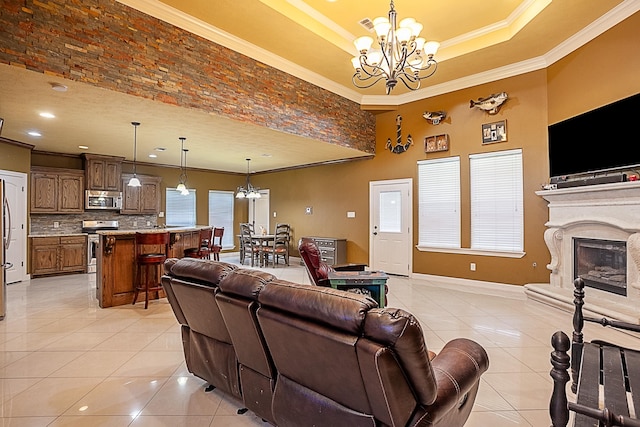 3812 Debbie Ave, Groves, TX 77619 - living room featuring a chandelier, light tile patterned flooring, crown molding, baseboards, and a raised ceiling