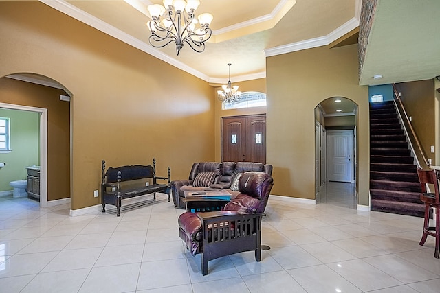 3812 Debbie Ave, Groves, TX 77619 - living room with arched walkways, a chandelier, crown molding, baseboards, and light tile patterned floors