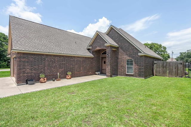 3812 Debbie Ave, Groves, TX 77619 - view of front of home with brick siding, roof with shingles, and a patio area