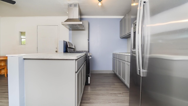 3875 Bowen Dr, Beaumont, TX 77708 - kitchen with stainless steel fridge with ice dispenser, island exhaust hood, range, gray cabinets, and light wood-style floors