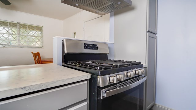 3875 Bowen Dr, Beaumont, TX 77708 - kitchen with gas range, exhaust hood, light countertops, and crown molding