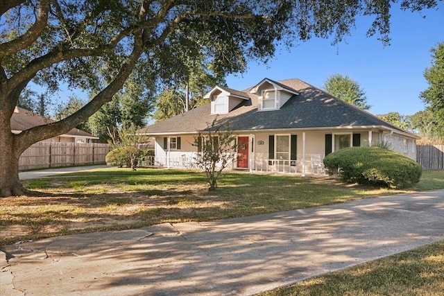 view of front of house with covered porch and a front yard