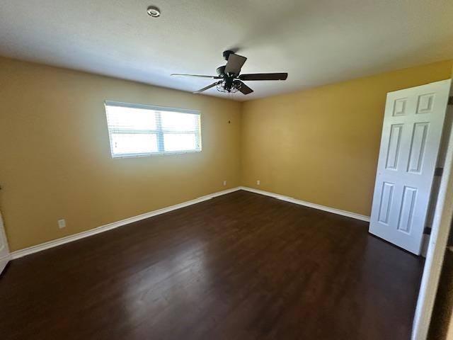 320 Meadow Dr, Bridge City, TX 77611 - empty room featuring ceiling fan, dark wood-type flooring, and baseboards