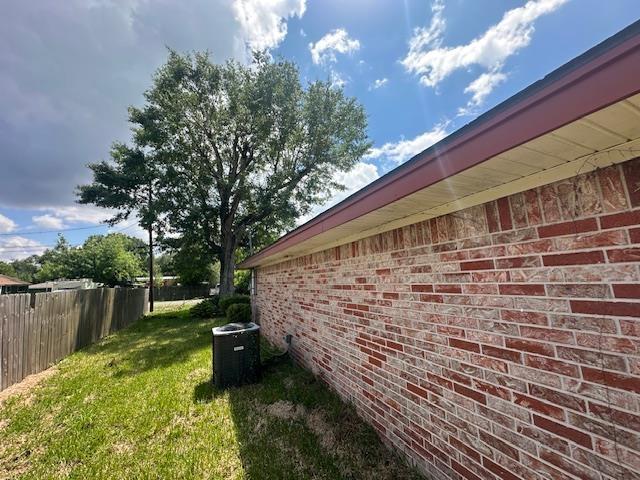 320 Meadow Dr, Bridge City, TX 77611 - view of home's exterior with brick siding and central air condition unit
