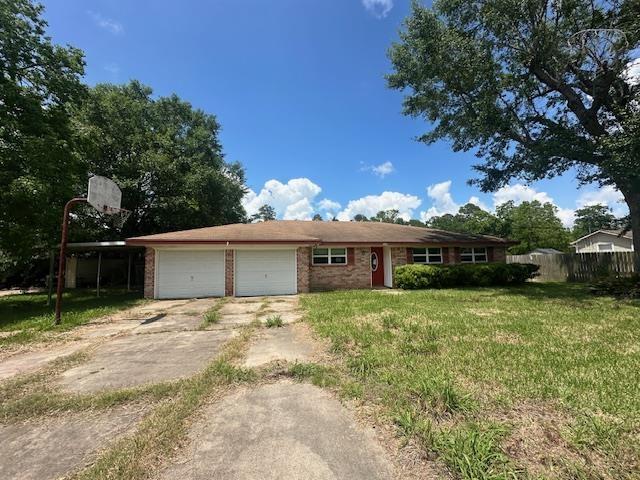 320 Meadow Dr, Bridge City, TX 77611 - ranch-style home with concrete driveway, an attached garage, and brick siding