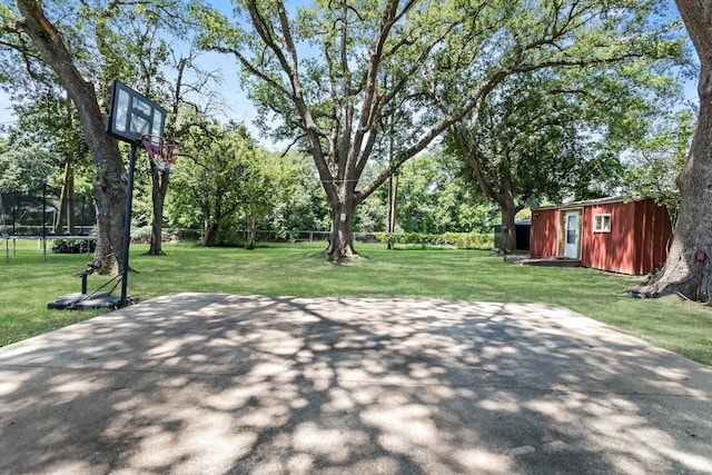 view of patio with a trampoline, an outbuilding, and a storage shed