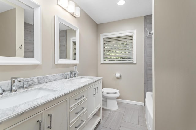 bathroom with toilet, double vanity, baseboards, a shower, and a bathtub
