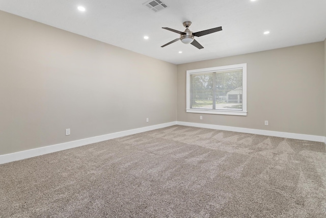 carpeted empty room with a ceiling fan, baseboards, and recessed lighting
