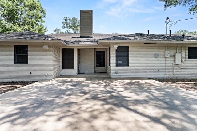 back of house featuring a patio and a chimney