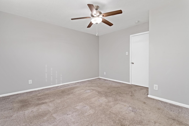 empty room featuring carpet floors and ceiling fan