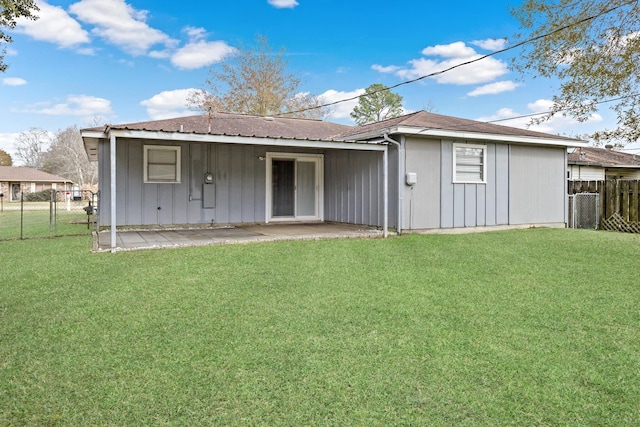 rear view of property with a lawn and a patio area