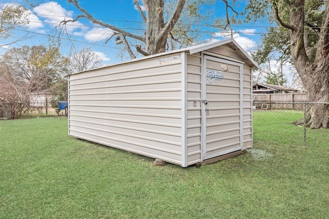 view of outbuilding with a lawn