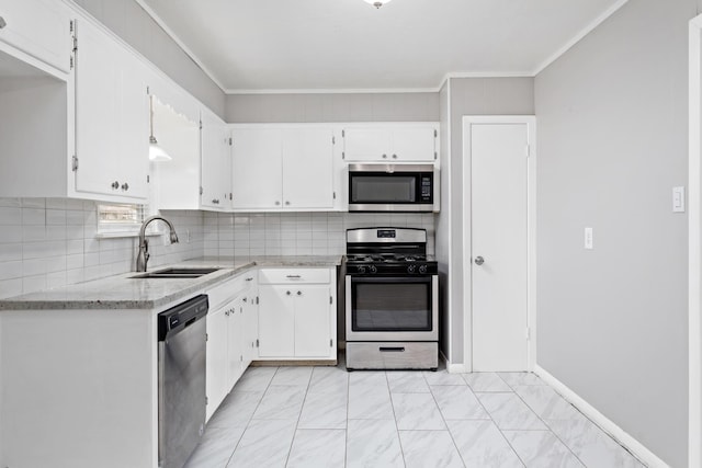 kitchen with white cabinetry, appliances with stainless steel finishes, sink, and backsplash