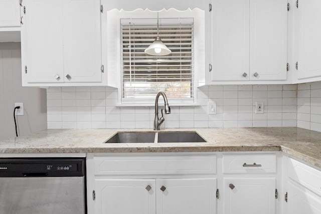 kitchen featuring tasteful backsplash, sink, white cabinets, and dishwasher