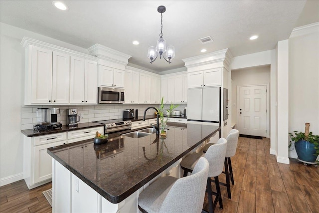 9270 Pampas St, Beaumont, TX 77713 - kitchen with a sink, decorative backsplash, visible vents, baseboards, and appliances with stainless steel finishes