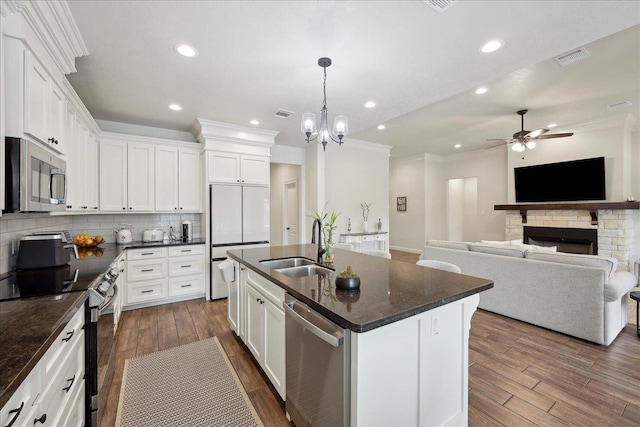 9270 Pampas St, Beaumont, TX 77713 - kitchen with stainless steel appliances, ornamental molding, ceiling fan with notable chandelier, backsplash, and a sink