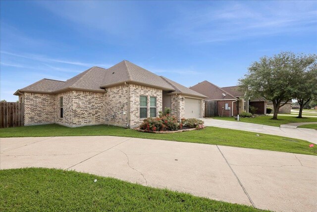 9270 Pampas St, Beaumont, TX 77713 - view of front of house with driveway, a front yard, fence, brick siding, and a garage