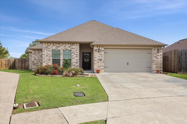 9270 Pampas St, Beaumont, TX 77713 - view of front of home featuring fence, a front yard, and brick siding