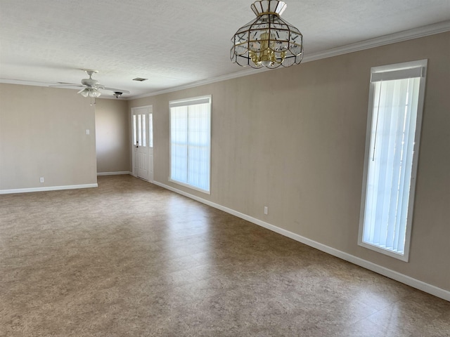 spare room with tile patterned floors, baseboards, and crown molding