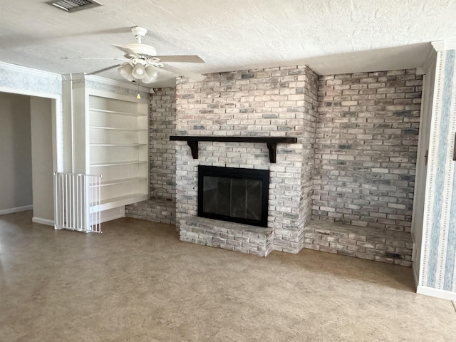 unfurnished living room with ceiling fan, a brick fireplace, and a textured ceiling