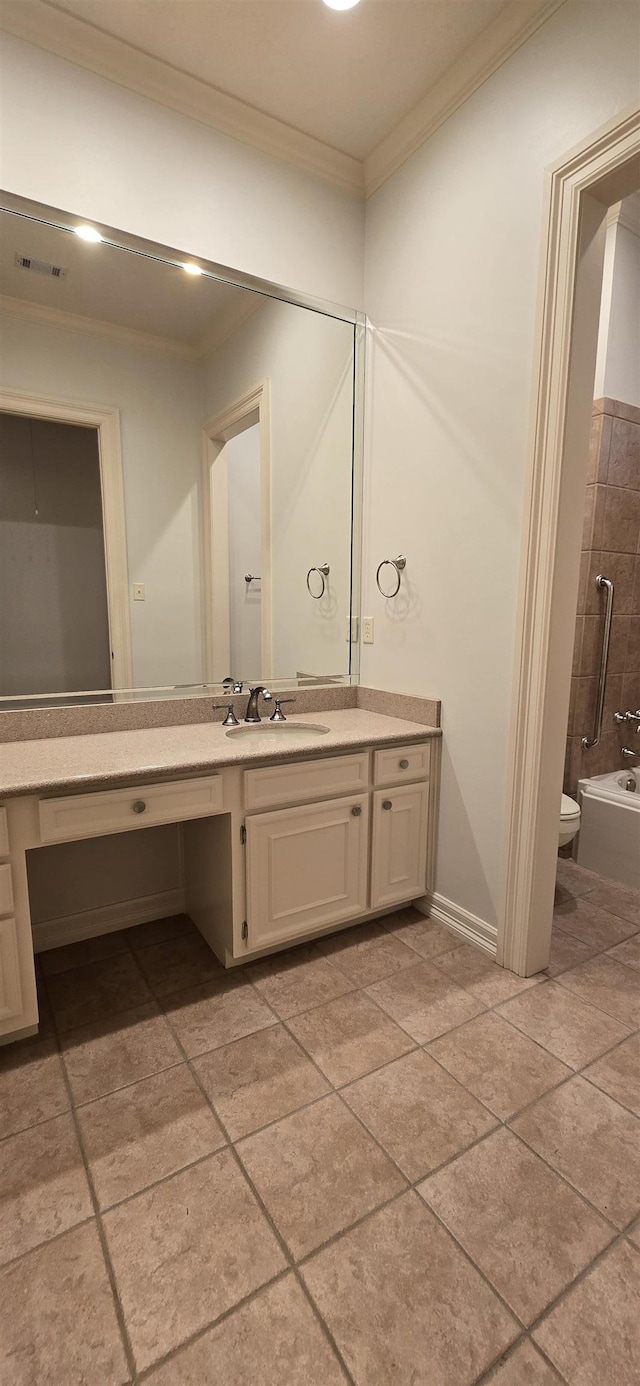 bathroom with visible vents, crown molding, toilet, a bathtub, and vanity