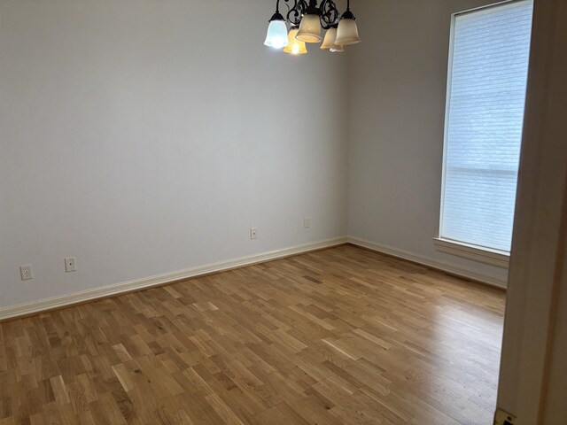 1470 Sheridan Ln, Beaumont, TX 77706 - unfurnished room featuring a chandelier, light wood finished floors, and baseboards