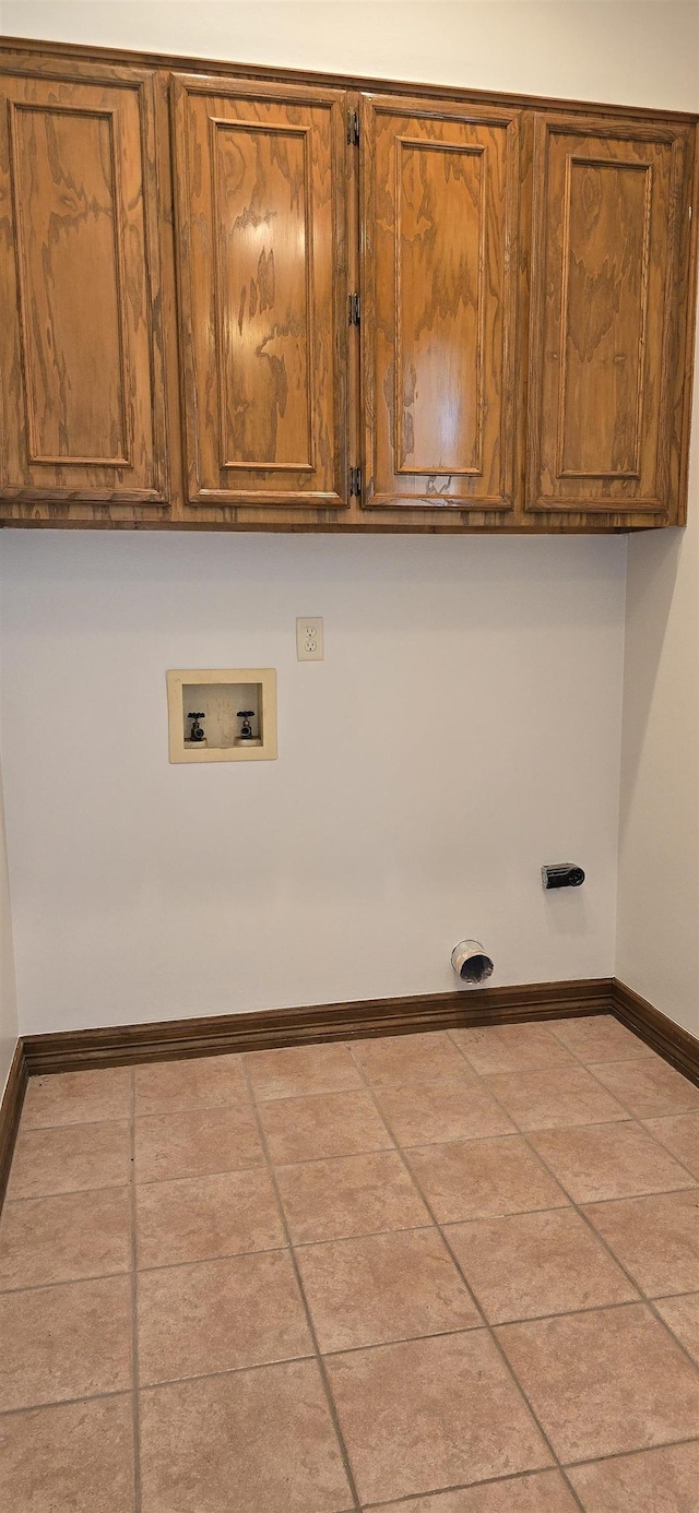 clothes washing area featuring hookup for a washing machine, cabinet space, and baseboards