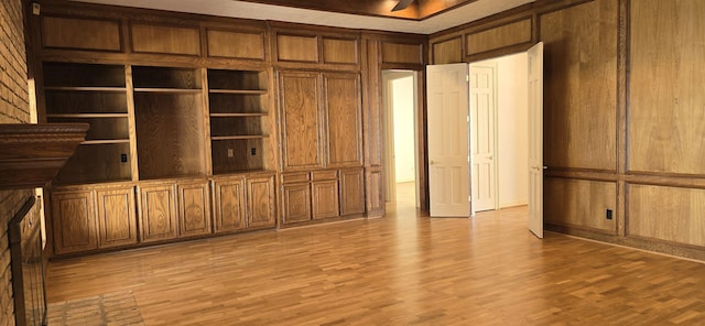 interior space with wood walls and light wood-style floors