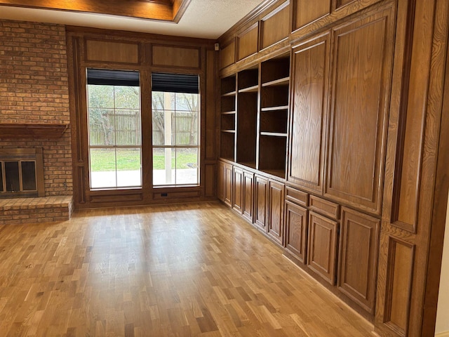 1470 Sheridan Ln, Beaumont, TX 77706 - unfurnished room featuring light wood finished floors, a fireplace, and built in features