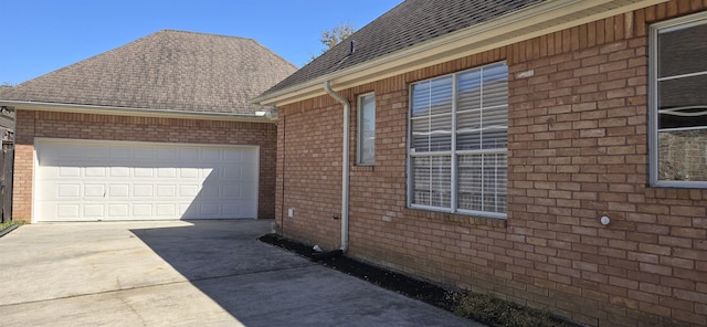 view of home's exterior featuring brick siding and driveway