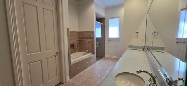 full bathroom featuring a garden tub, double vanity, tile patterned floors, and a sink