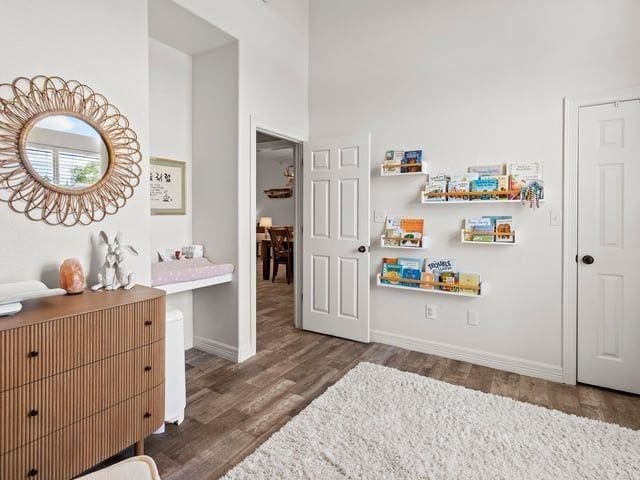 bedroom featuring wood finished floors and baseboards