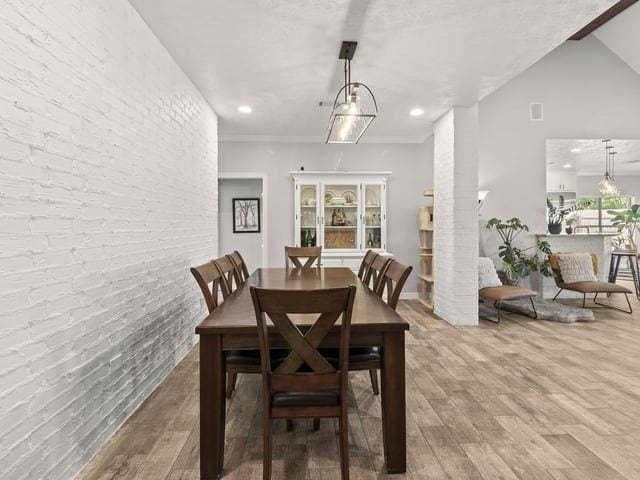 dining room featuring recessed lighting, visible vents, ornamental molding, and wood finished floors