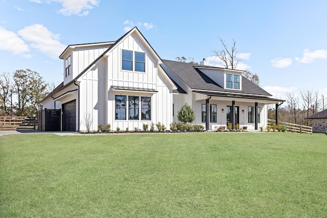 back of house with a lawn, a porch, and a garage